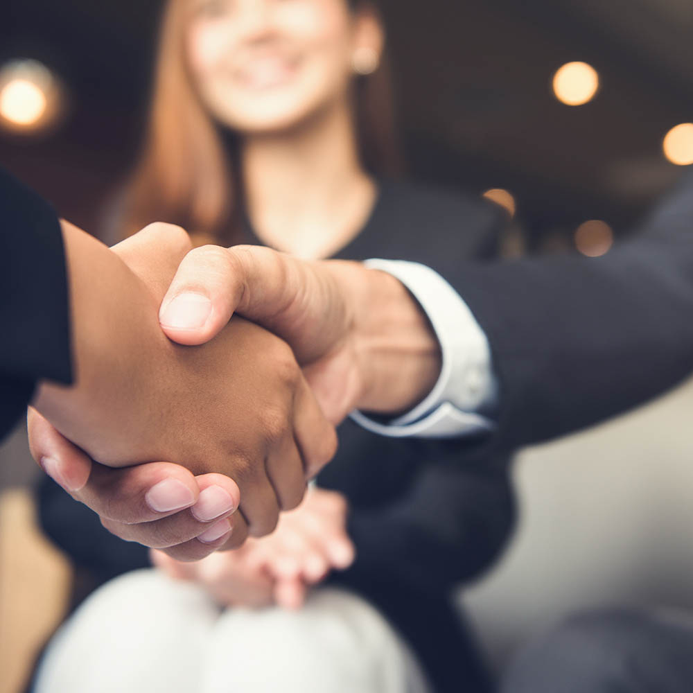 Businessmen shaking hands after meeting in a cafe